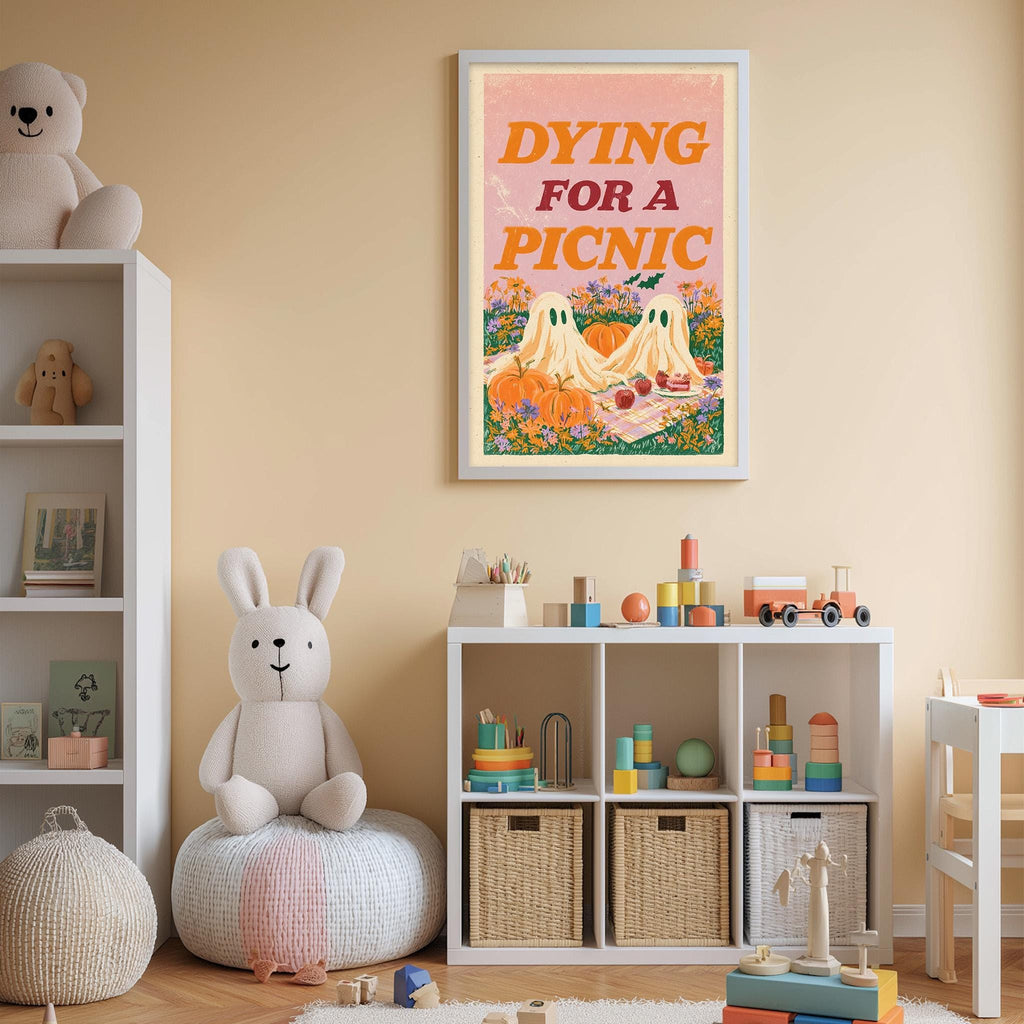 A child's bedroom with a stuffed rabbit, a bookshelf, and a framed poster on the wall. The poster features a cartoon illustration of a picnic scene with ghostly figures and pumpkins.