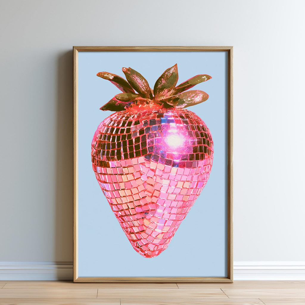 A framed image of a pink disco ball with a strawberry design, set against a light blue background.