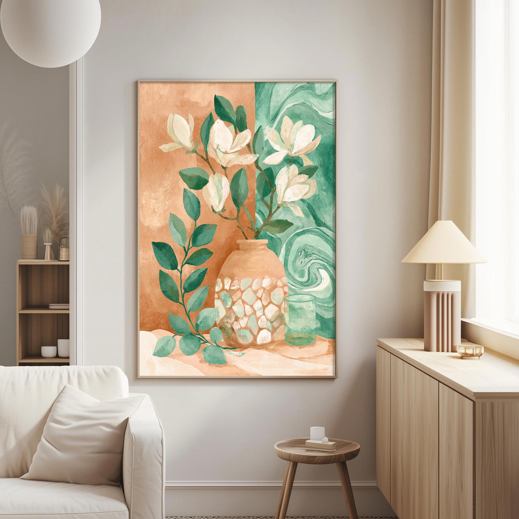 a living room with a large painting of a vase filled with white flowers and green leaves hanging on the wall. The painting is framed in a brown frame and is the focal point of the room. The room also includes a white sofa, a wooden side table, and a lamp on a nearby table.