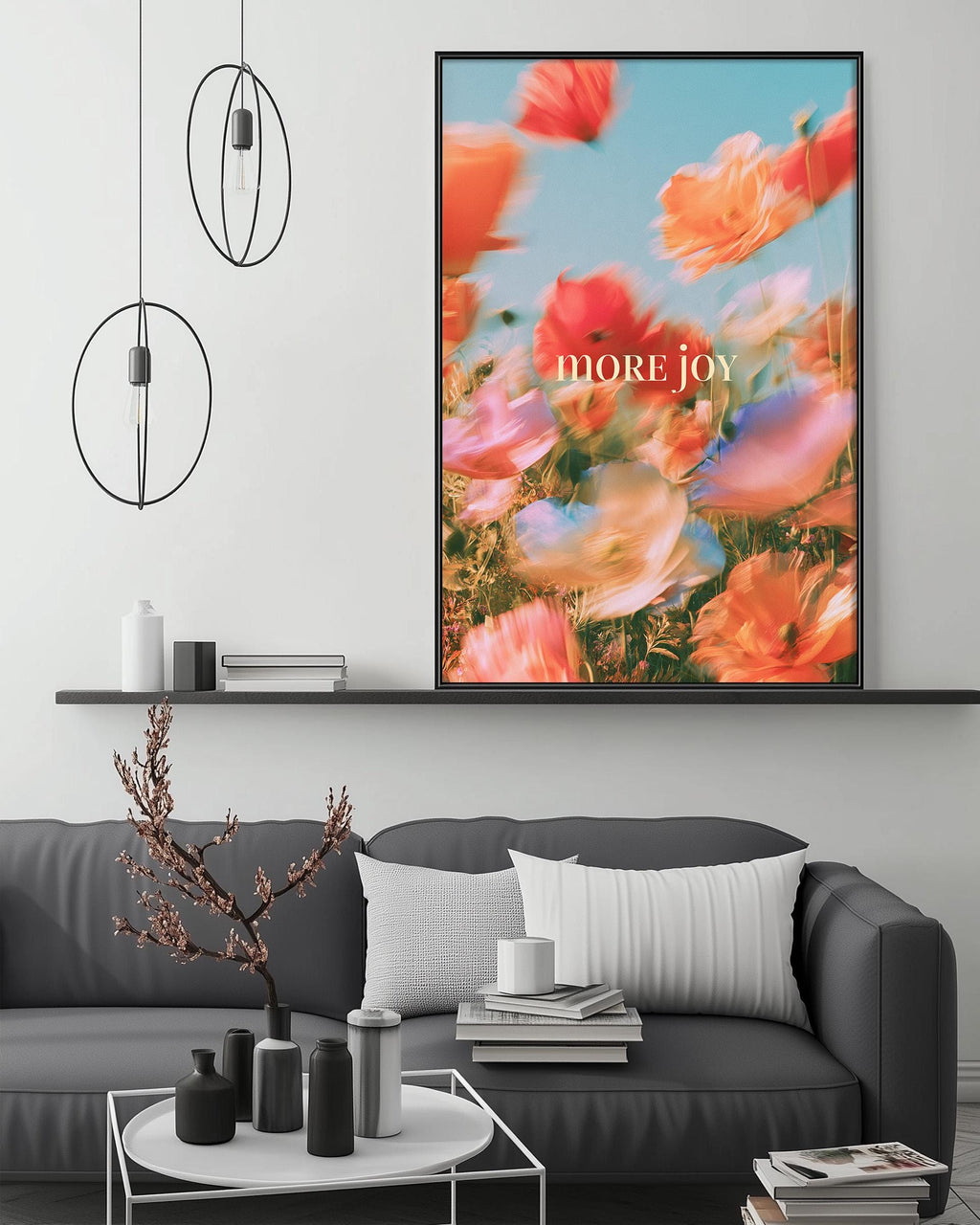 a modern living room with a gray sofa, a coffee table, and a large framed poster of a colorful flower field above it.
