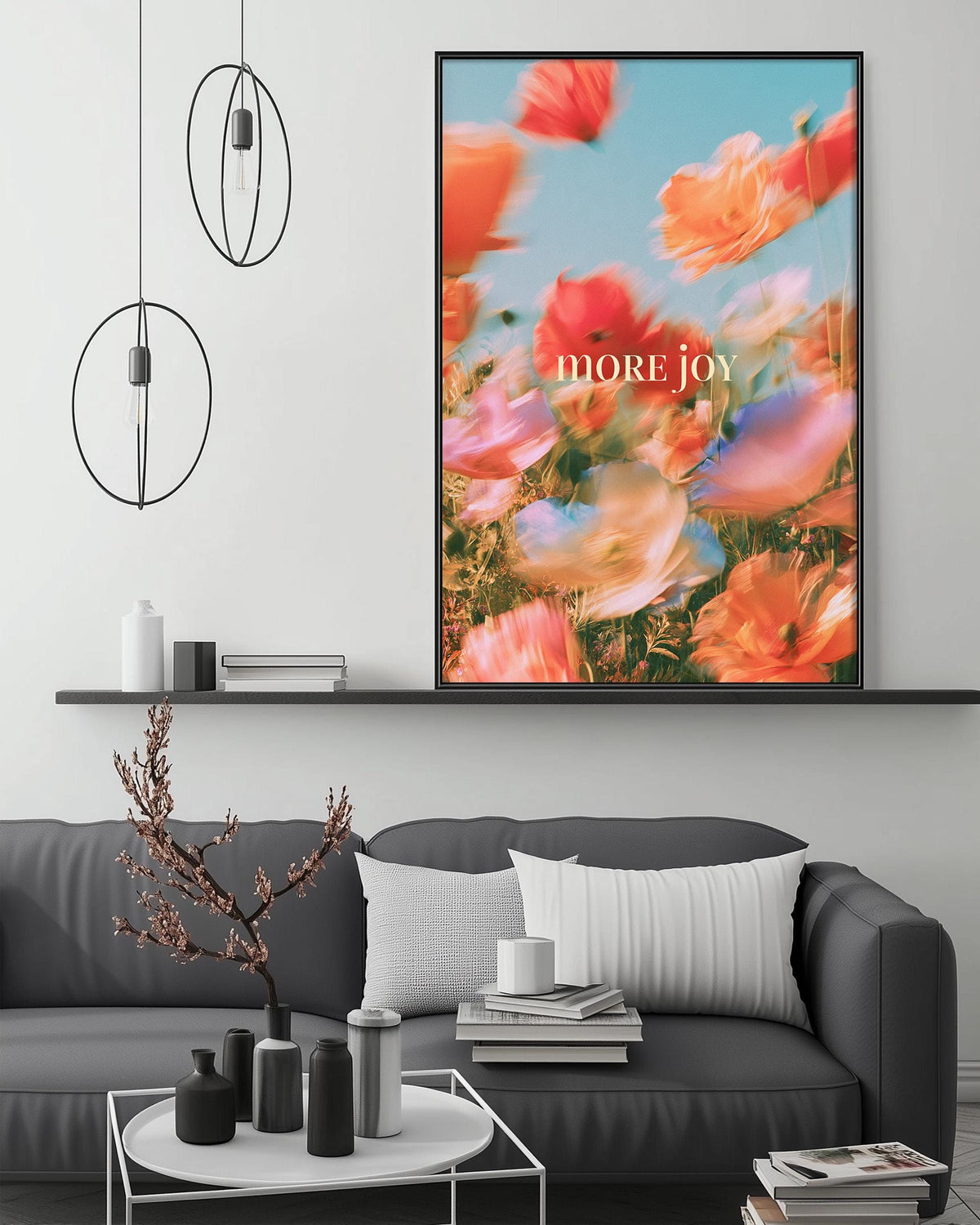 a modern living room with a gray sofa, a coffee table, and a large framed poster of a colorful flower field above it.