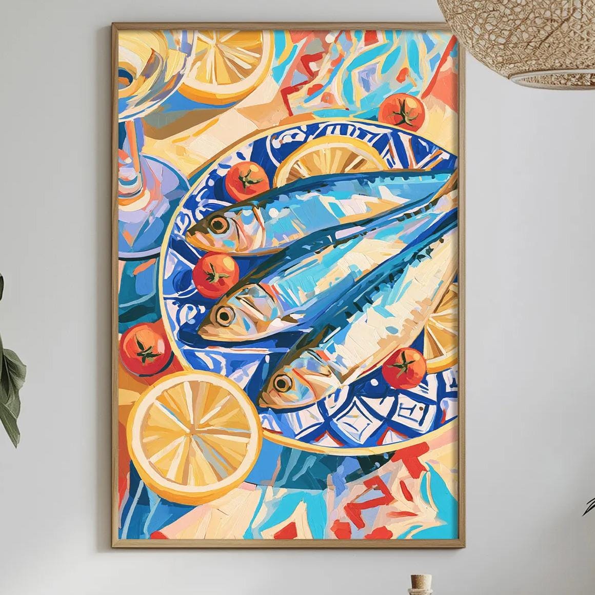 a dining table with a white tablecloth, a bowl of fruit, a bottle, and a vase with flowers. Above the table, there is a framed painting of fish and fruit on a plate.