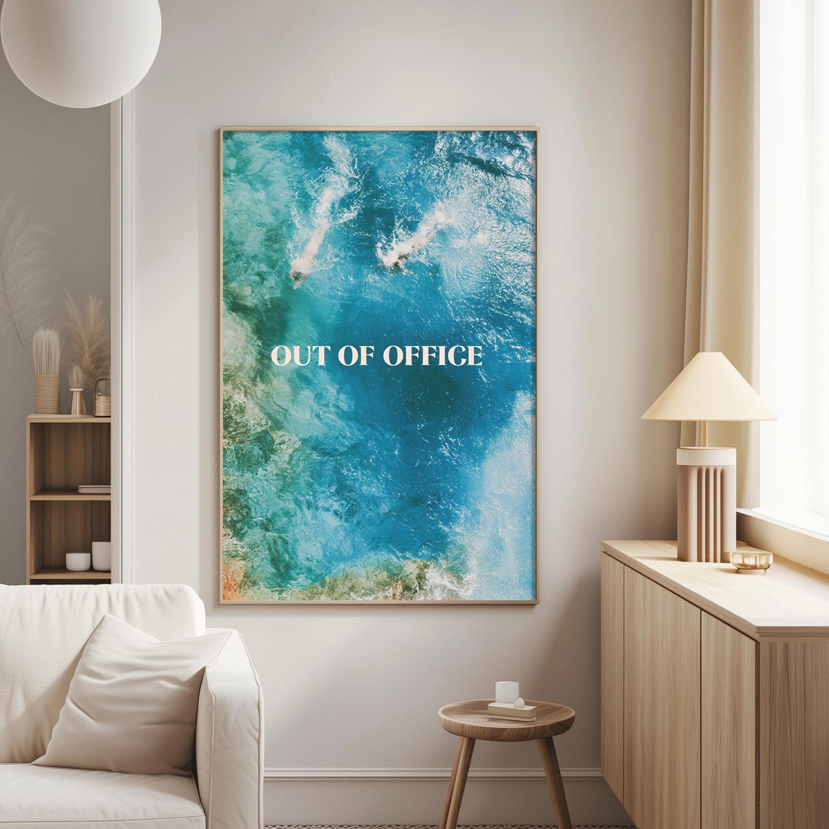 a large framed poster with the text "OUT OF OFFICE" on it, hanging on a wall in a living room setting.