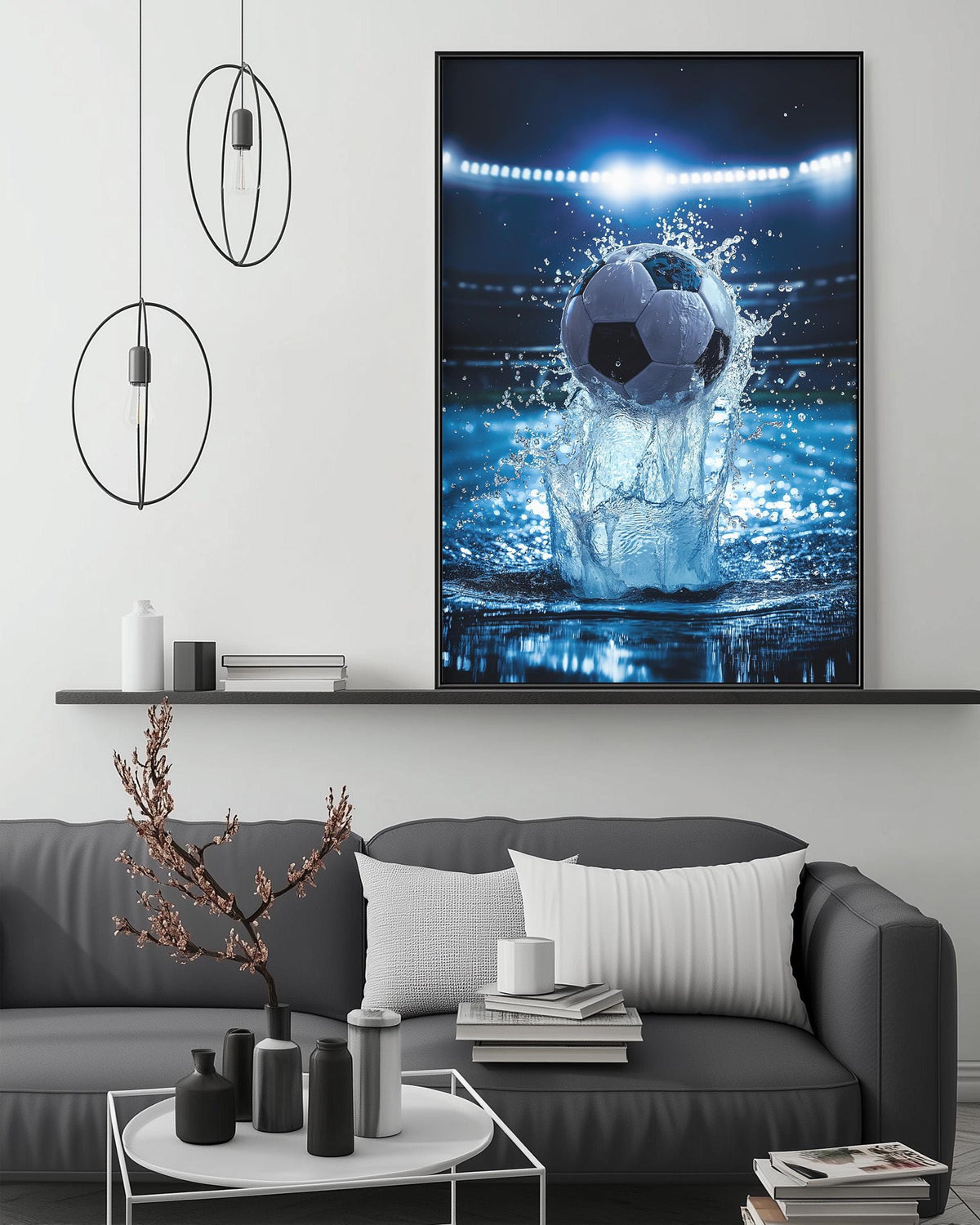 a large framed picture of a soccer ball being splashed by water, hanging on a wall above a gray couch in a living room setting.