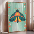 A framed poster of a colorful butterfly is displayed on a wall in a room with a window.