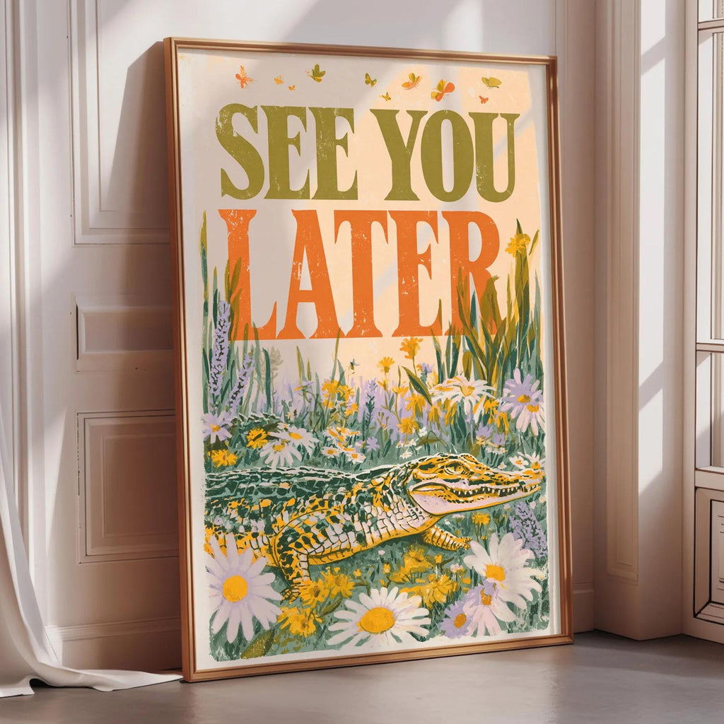 a framed poster with a large text that reads "See you later" and an illustration of a crocodile surrounded by flowers.
