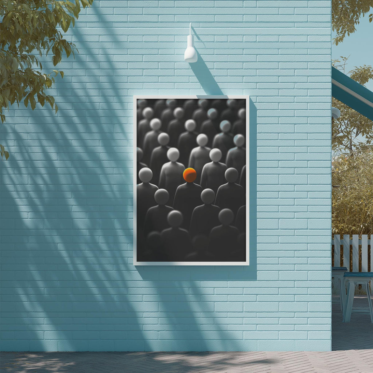 a framed artwork hanging on a blue wall, depicting a group of people with one individual standing out in a bright orange color.