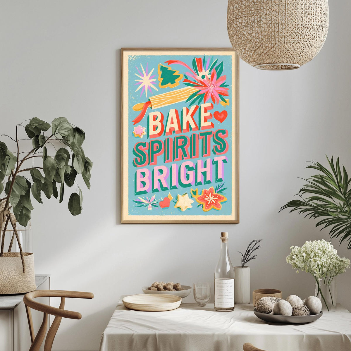 a colorful poster with the text "BAKE SPIRITS BRIGHT" hanging on a wall above a dining table with various decorative items and plants.