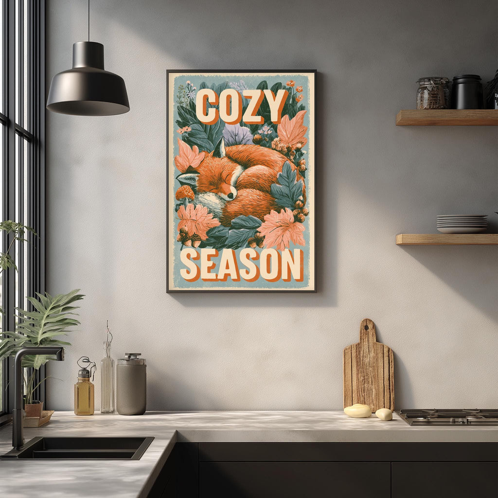 a kitchen counter with various kitchen items, including a cutting board, a bottle, and a bowl. Above the counter, there is a framed poster with a fox and flowers, and the text "COZY SEASON" is written on it.