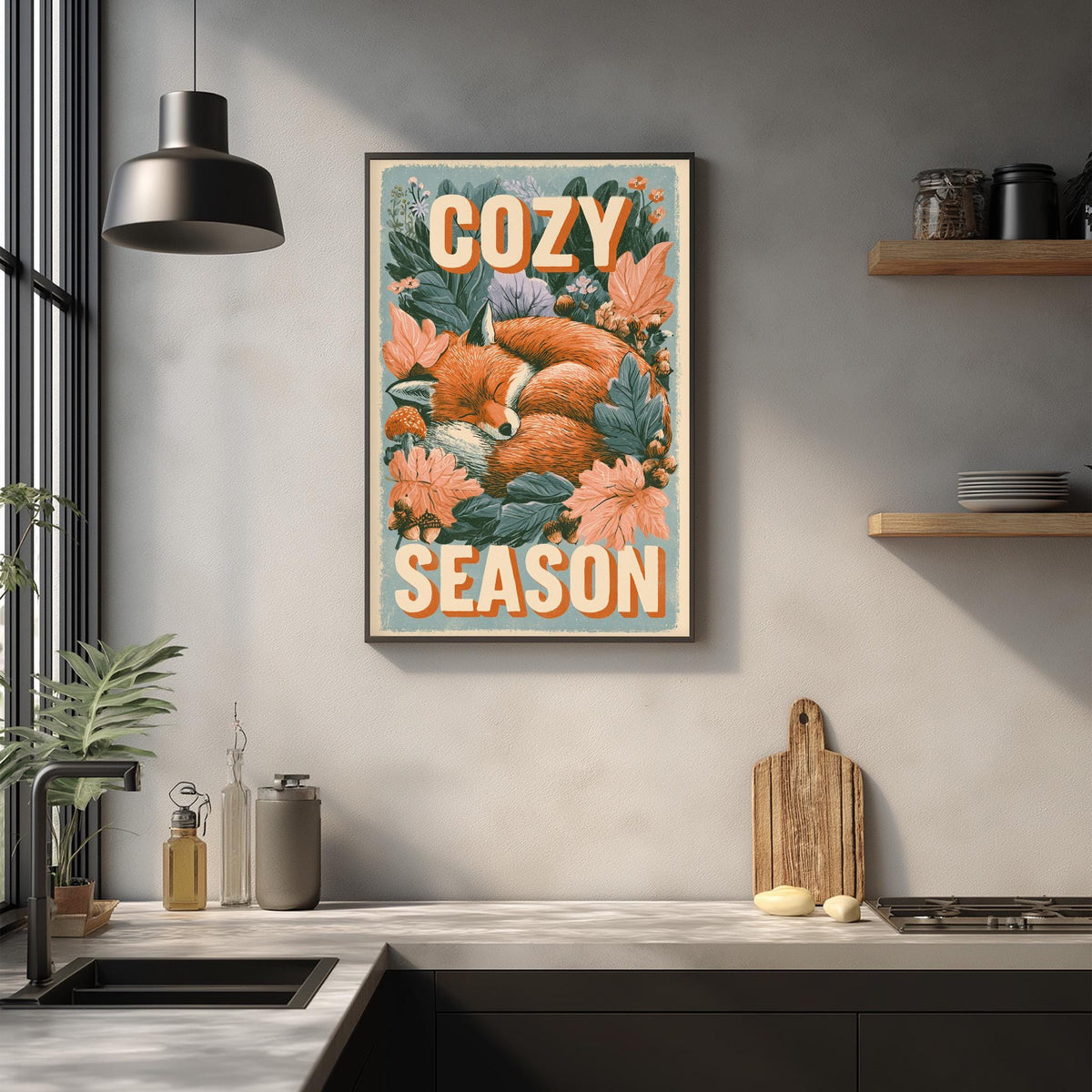 a kitchen counter with various kitchen items, including a cutting board, a bottle, and a bowl. Above the counter, there is a framed poster with a fox and flowers, and the text "COZY SEASON" is written on it.