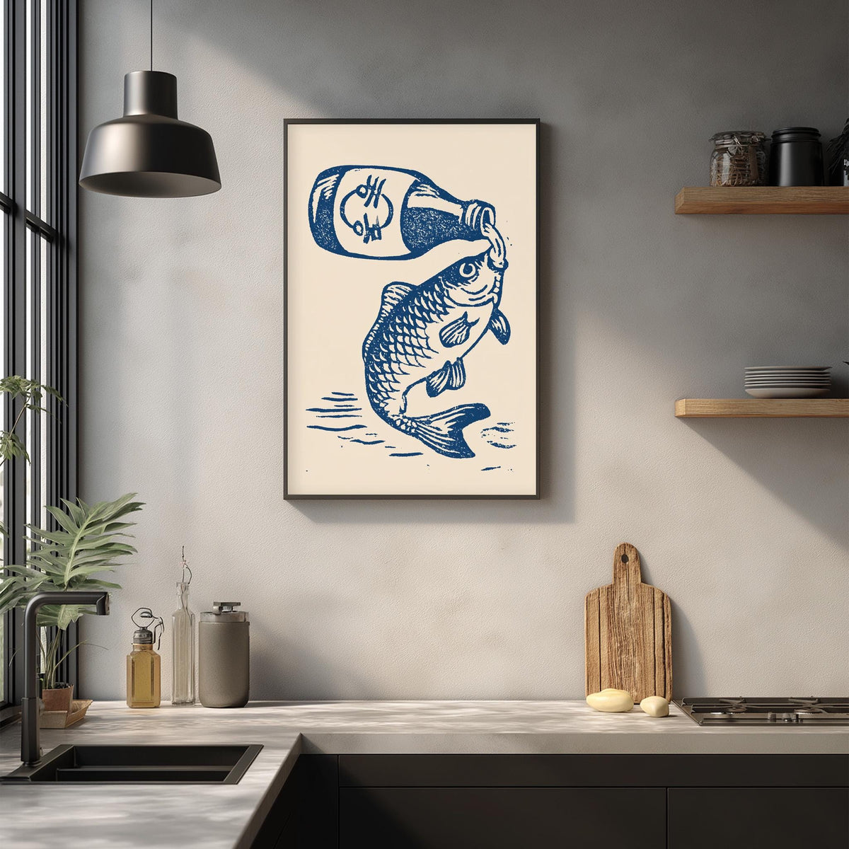 a framed illustration of a fish with a bottle of beer, hanging on a wall above a kitchen counter with various kitchen items and decor.