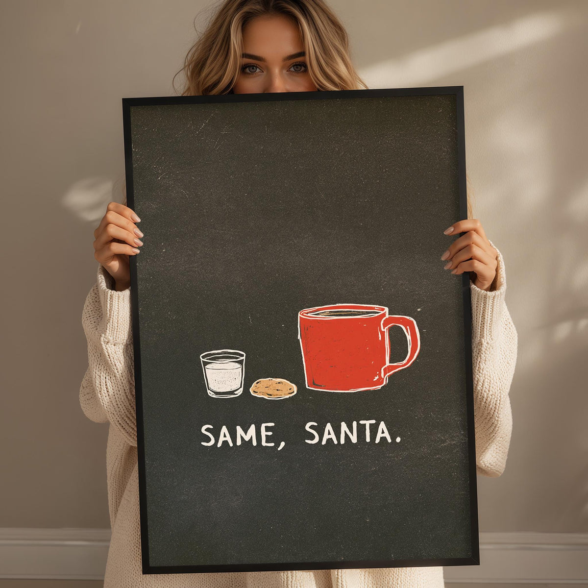 A woman holding a black frame with a white text and an illustration of a red mug and a glass of milk, along with the text "SAME, SANTIA."