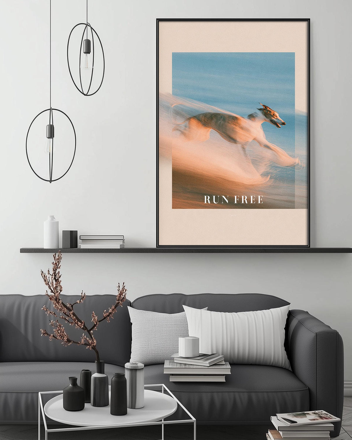a modern living room with a gray sofa, a coffee table, and a large framed poster of a dog running in the background. The poster has the text "RUN FREE" written on it.