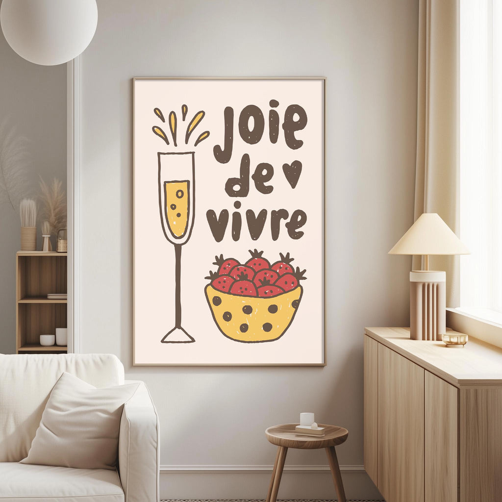 a living room with a white couch, a wooden side table, and a framed poster on the wall. The poster has a drawing of a glass of champagne and a bowl of strawberries, along with the text "JOIE DE VIVRE" which means "Happy Vivid" in French.