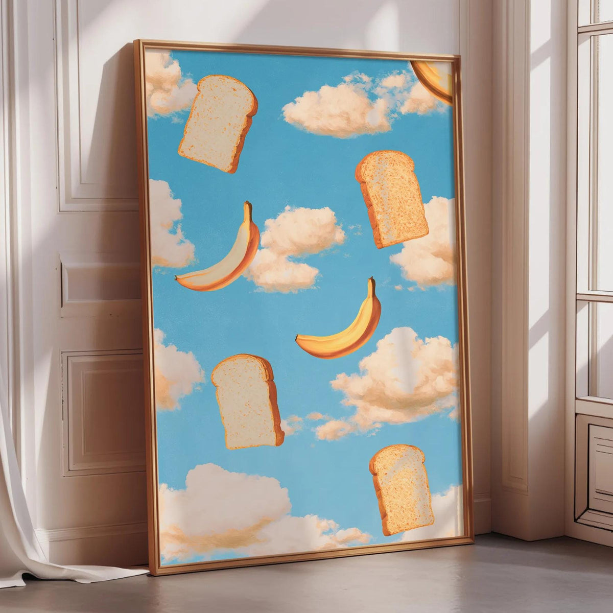 a large framed poster with a whimsical design of bread and bananas floating in a blue sky with clouds.