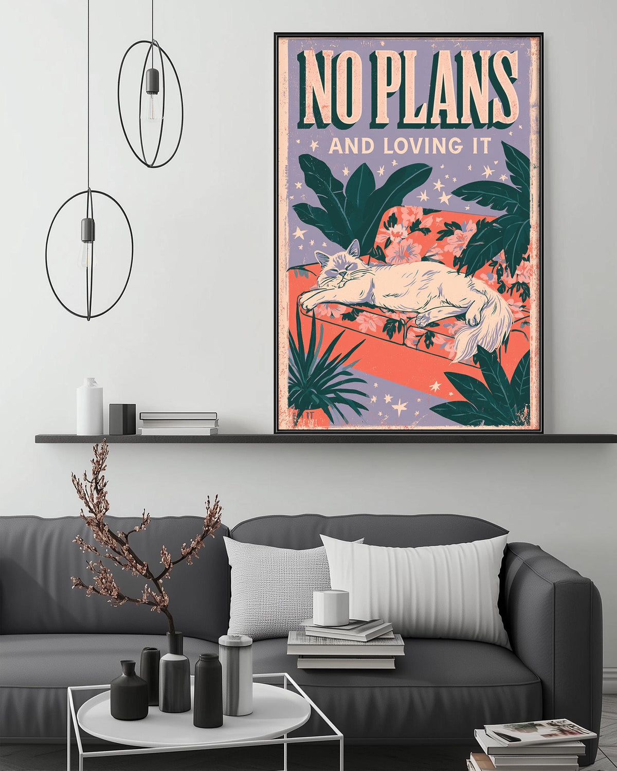 a poster with the text "NO PLANS AND LOVING IT" displayed on a wall above a gray couch with a coffee table in front of it.