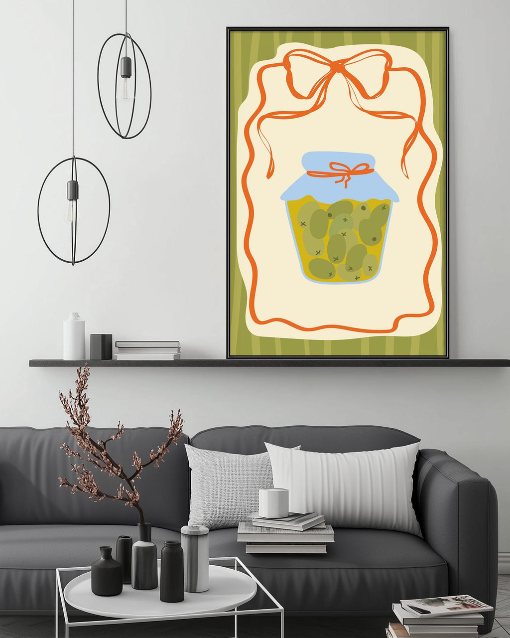 a cozy living room with a gray couch, a coffee table, and a large framed illustration of a jar of pickles on the wall.