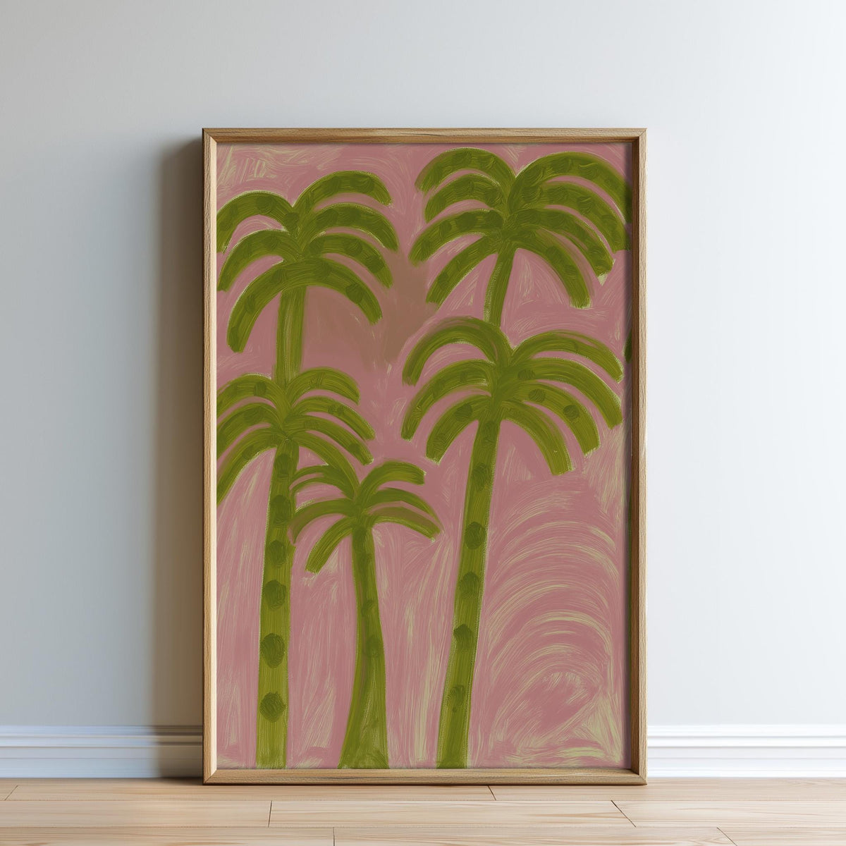 a framed painting of palm trees with green leaves against a pink background.