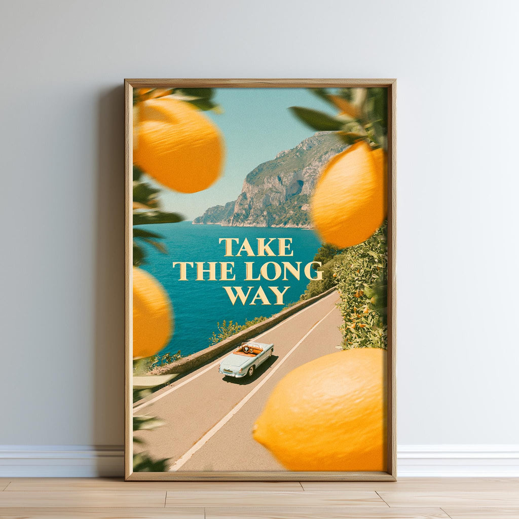 The image is a framed poster with a scenic road leading to a mountainous landscape, featuring a vintage car driving along the road.