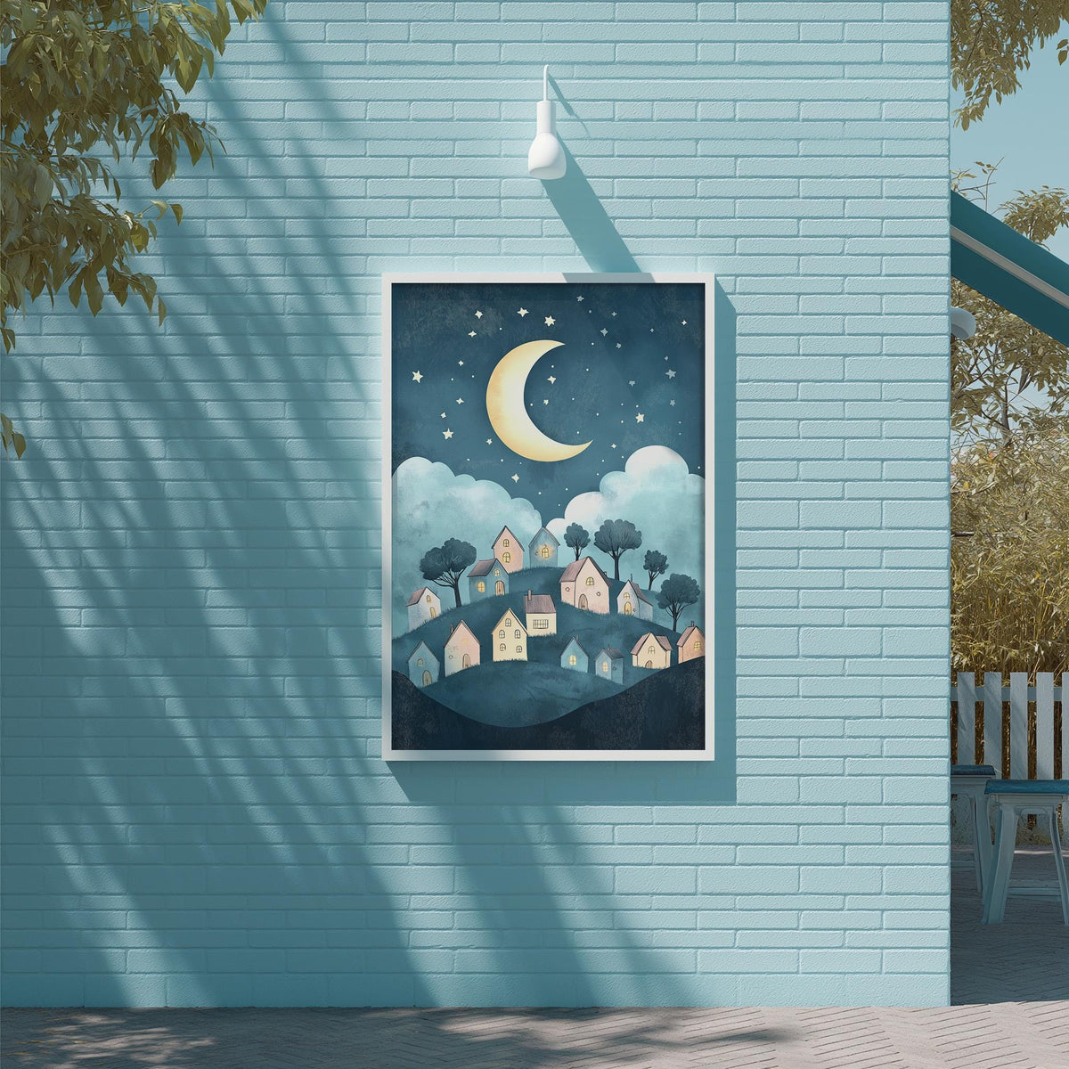 a blue brick wall with a framed illustration of a nighttime village scene, including a crescent moon and stars, and houses on a hill.