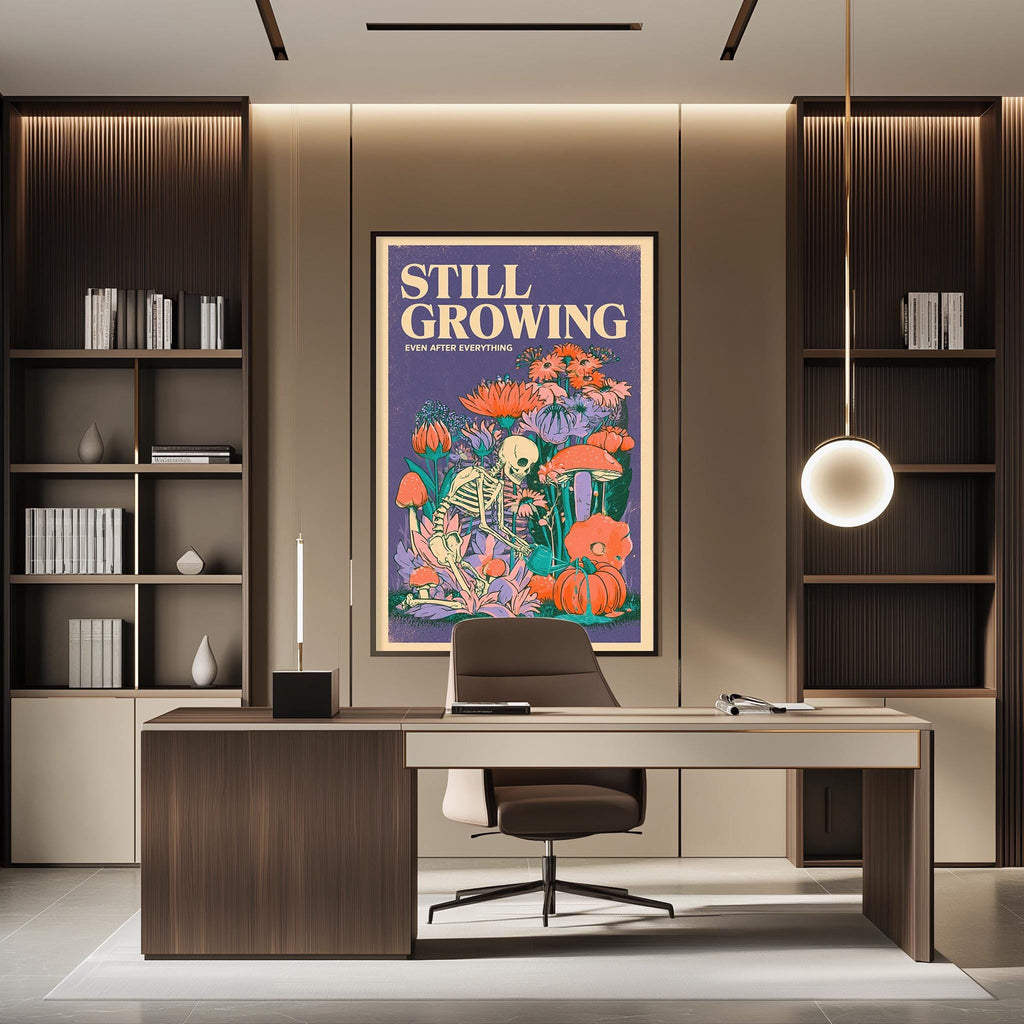 a modern office space with a large framed poster on the wall that reads "STILL GROWING" and depicts a skeleton surrounded by flowers and mushrooms. The office has a wooden desk, a chair, and a bookshelf filled with books and various decorative items.