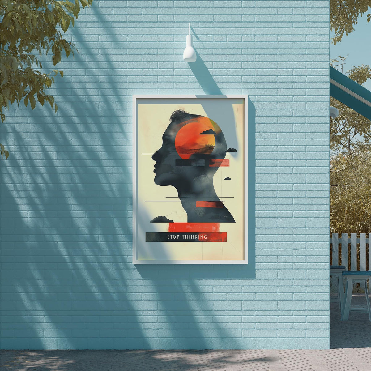 a poster with a silhouette of a person's head and the text "STOP THINKING" displayed on a blue brick wall.