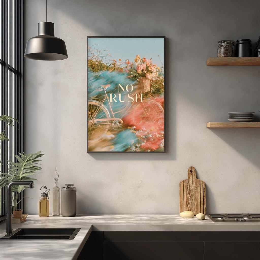 a kitchen counter with various items such as a cutting board, a soap dispenser, and a plant. Above the counter, there is a framed poster with the text "NO RUSH" displayed on it.