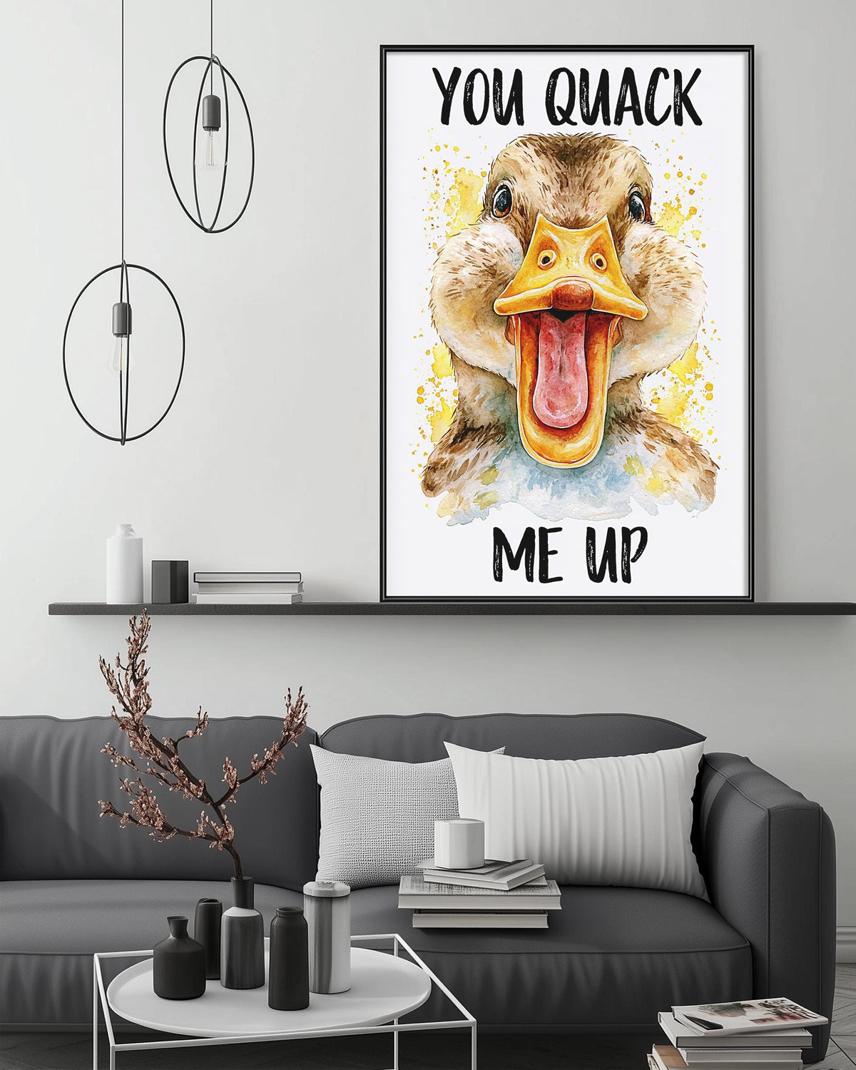 a large framed poster of a duck with a humorous text overlay, hanging on a wall above a gray couch in a living room setting.