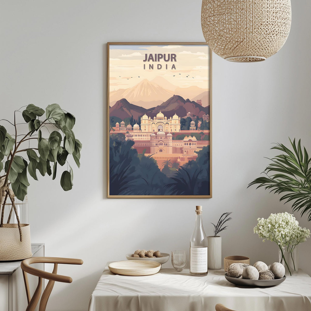 a framed poster of Jaipur, India, hanging on a wall above a dining table with various decorative items and plants.
