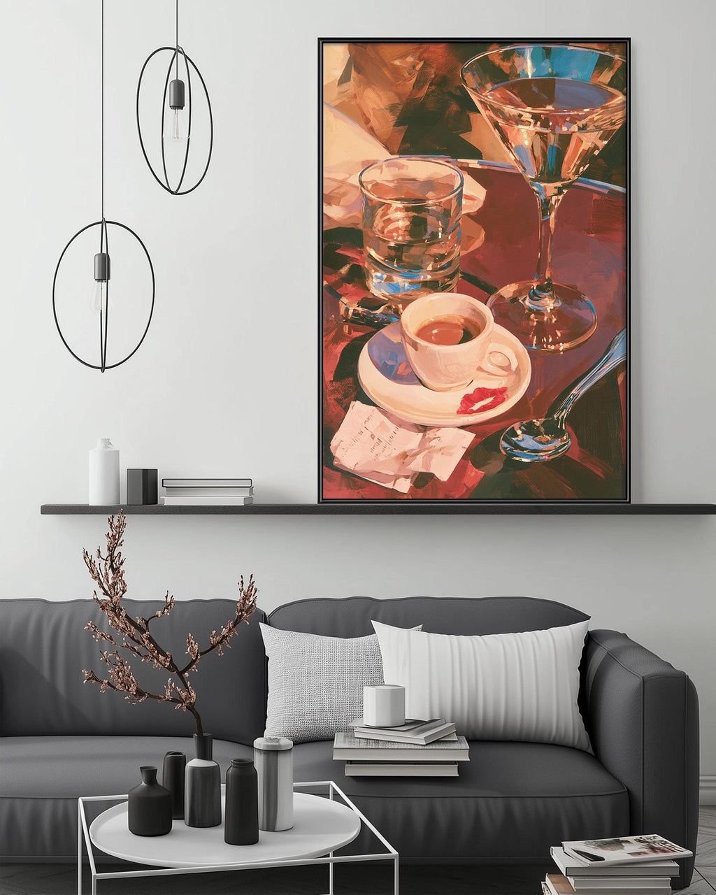 a cozy living room with a gray sofa, a coffee table, and a large painting of glasses and a cup on the wall.