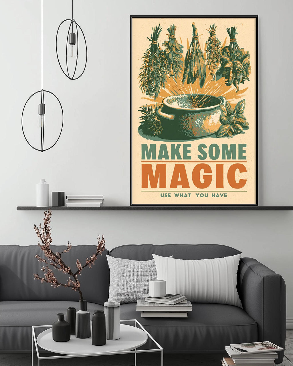 a living room with a gray couch, a coffee table, and a framed poster on the wall. The poster has a colorful illustration of various herbs and spices, along with the text "MAKE SOME MAGIC USE WHAT YOU HAVE".