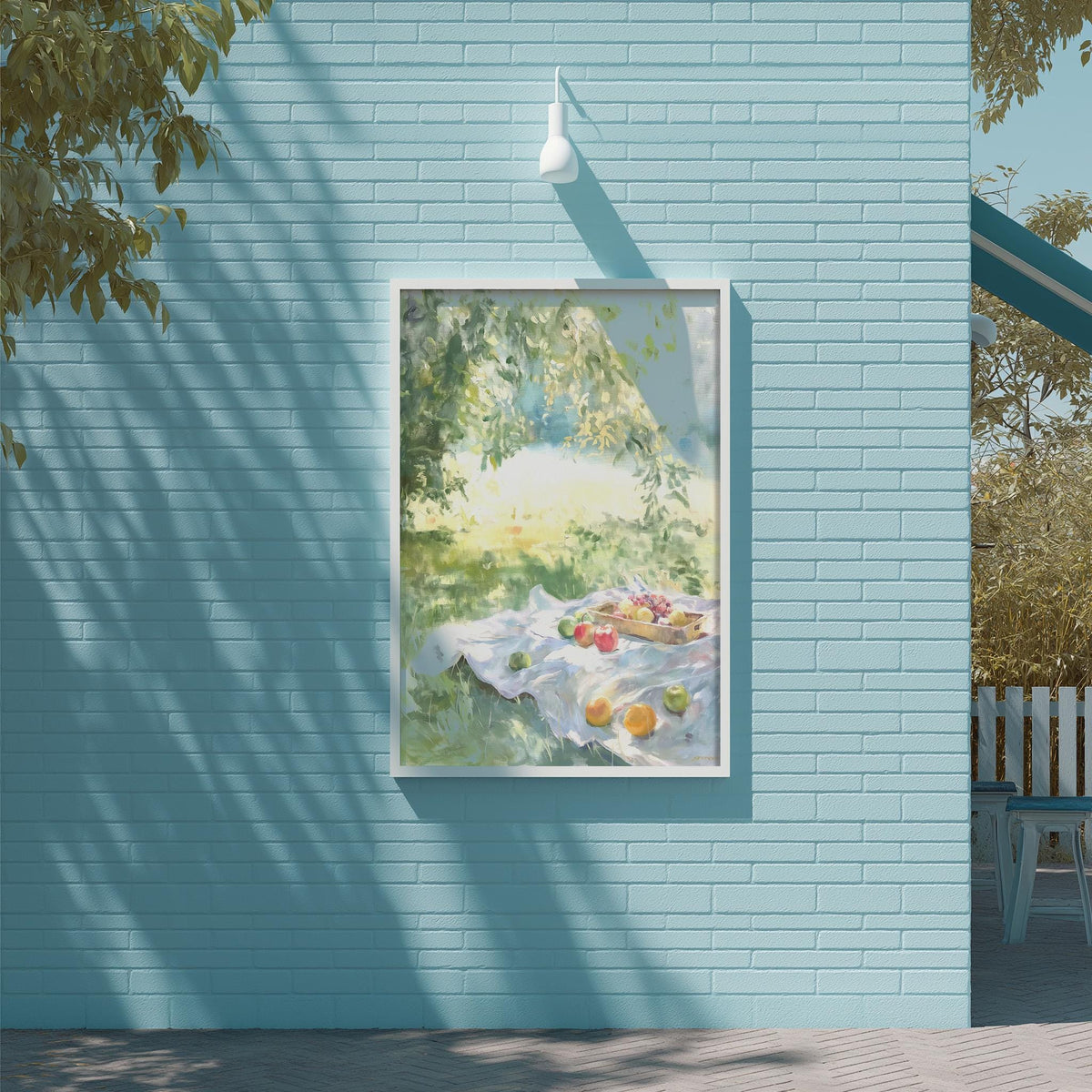 a blue brick wall with a framed painting of a picnic scene hanging on it.