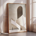 a large, framed artwork depicting a person walking up a white staircase with an arched doorway in the background.