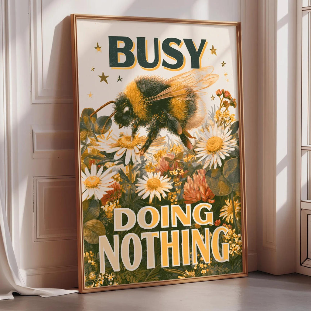 a framed poster with a bee and flowers, along with the text "BUSY DOING NOTHING".