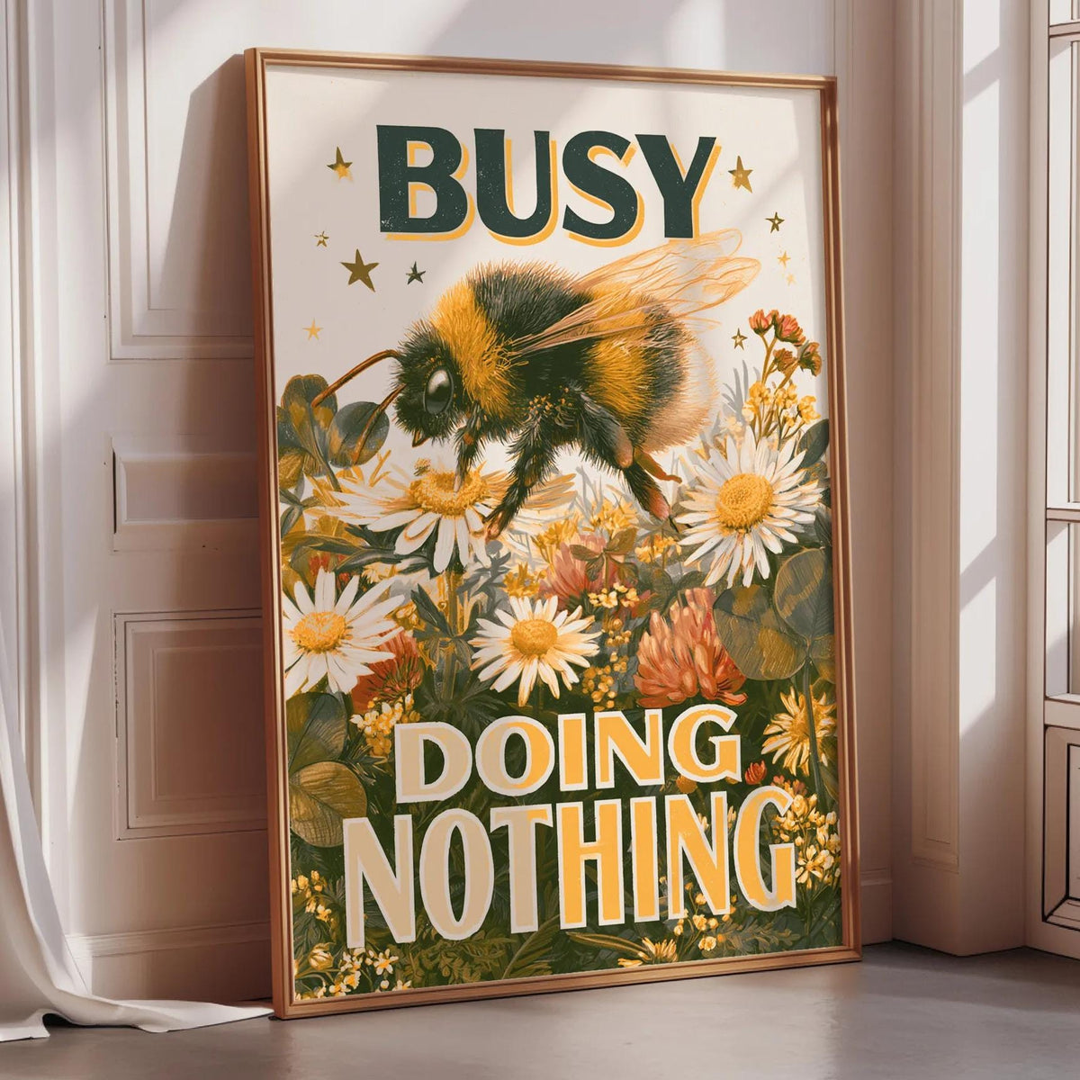 a framed poster with a bee and flowers, along with the text "BUSY DOING NOTHING".