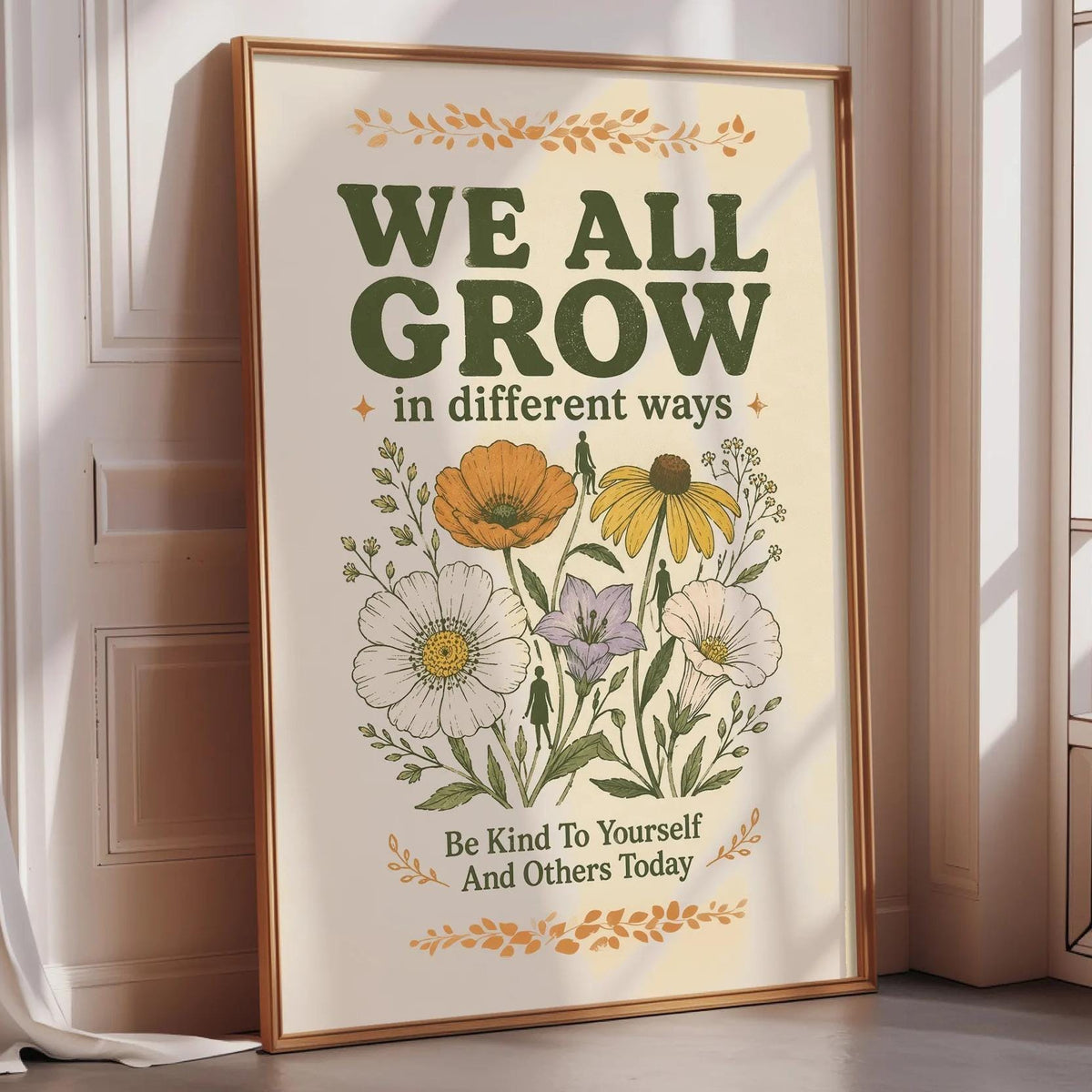 A framed poster with a floral design and the text "WE ALL GROW in different ways" is displayed on a wall.