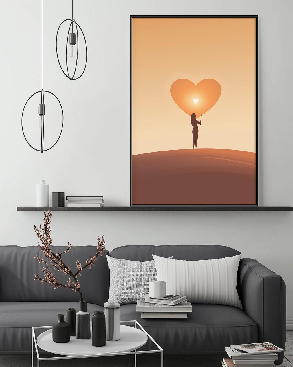 a cozy living room with a gray sofa, a coffee table, and a large framed picture of a woman holding a heart-shaped object, possibly a heart-shaped balloon or ornament. The room has a minimalist and modern design, with a black pendant light hanging above the sofa and a shelf displaying various decorative items.