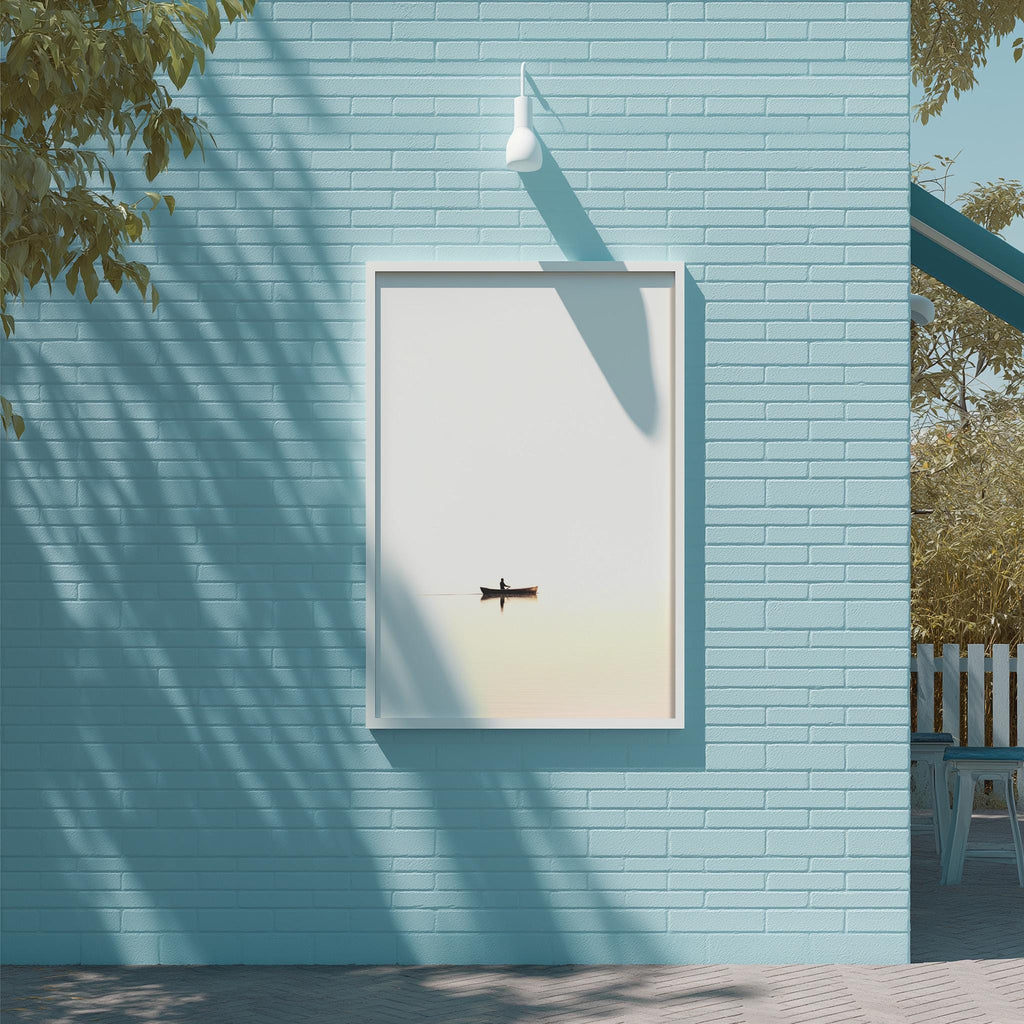 a blue brick wall with a white square frame containing a small black boat. The wall is shaded by a tree, creating a serene and peaceful atmosphere.