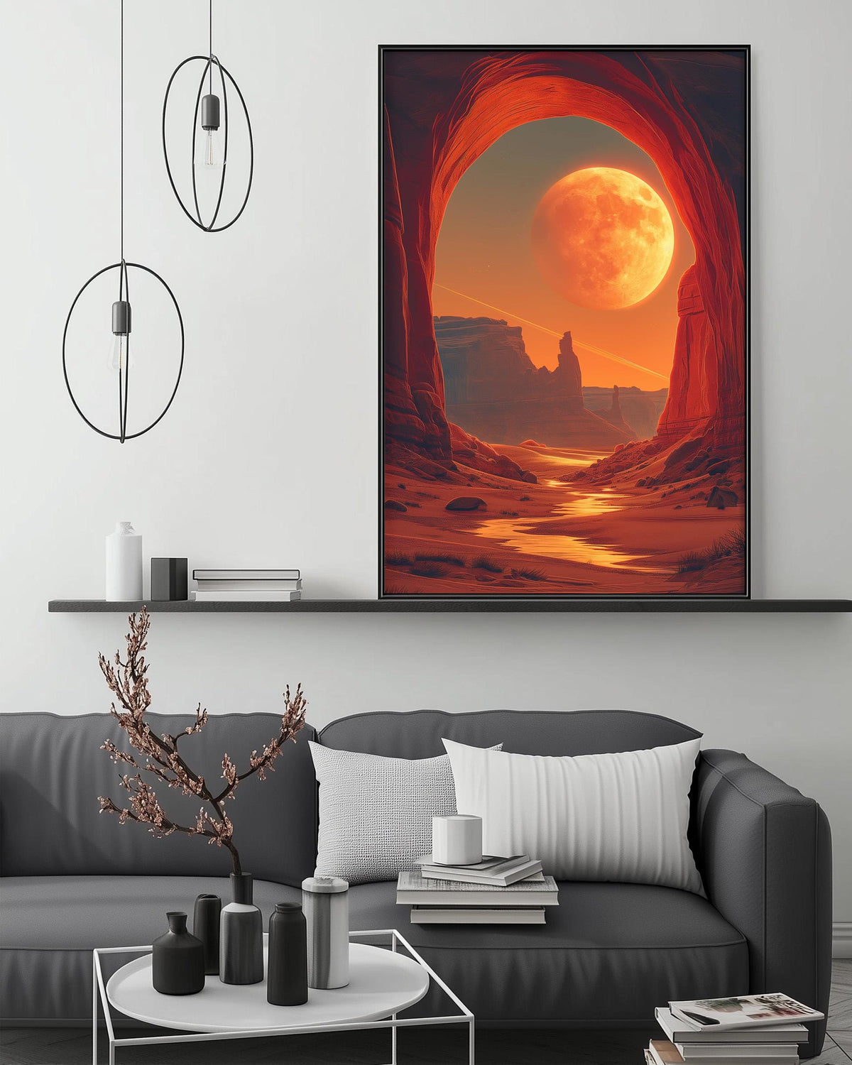 a large, vibrant painting of a desert landscape with a large, glowing moon in the sky. The painting is hanging on a wall above a gray couch, which is positioned in front of a coffee table. The room has a minimalist and modern design, with a few decorative items such as a potted plant, vases, and books on the coffee table.