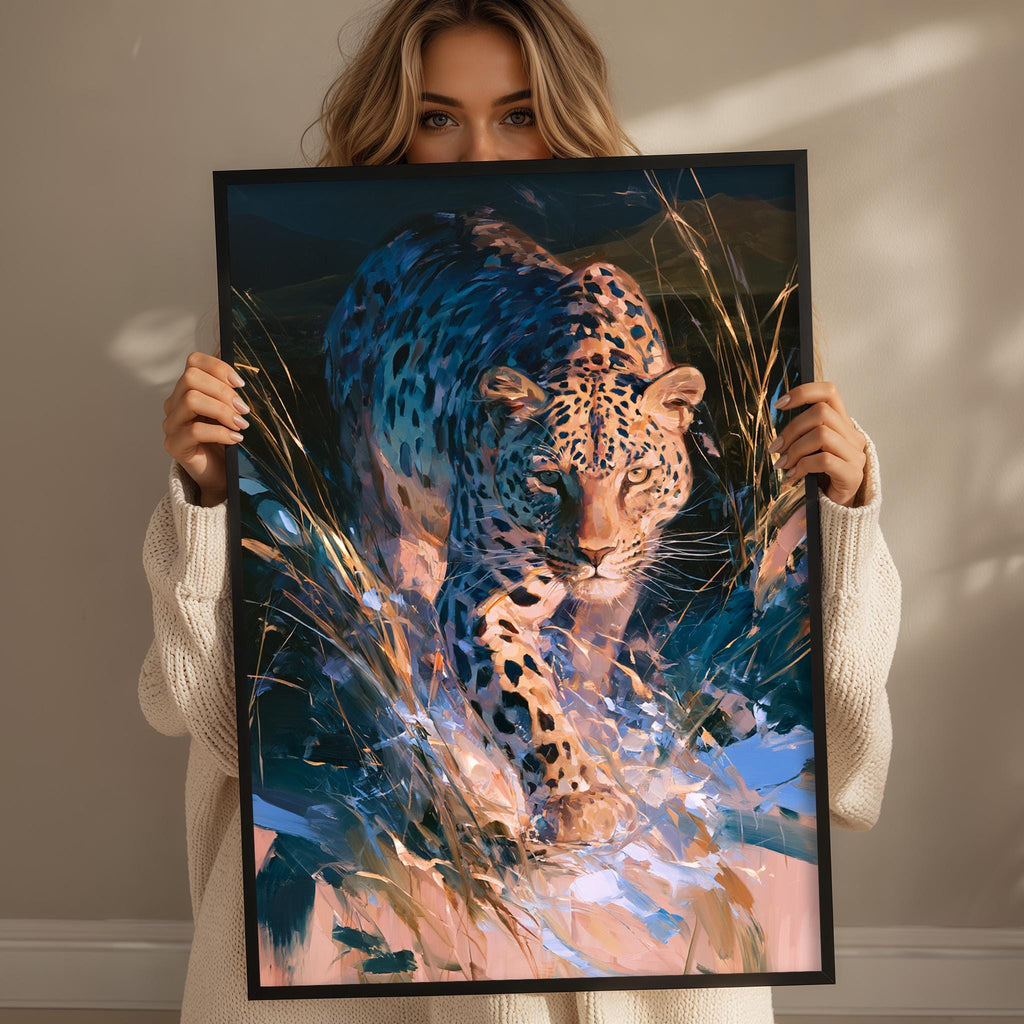 A woman holds up a framed painting of a leopard in a natural setting, showcasing the animal's distinctive spotted pattern.