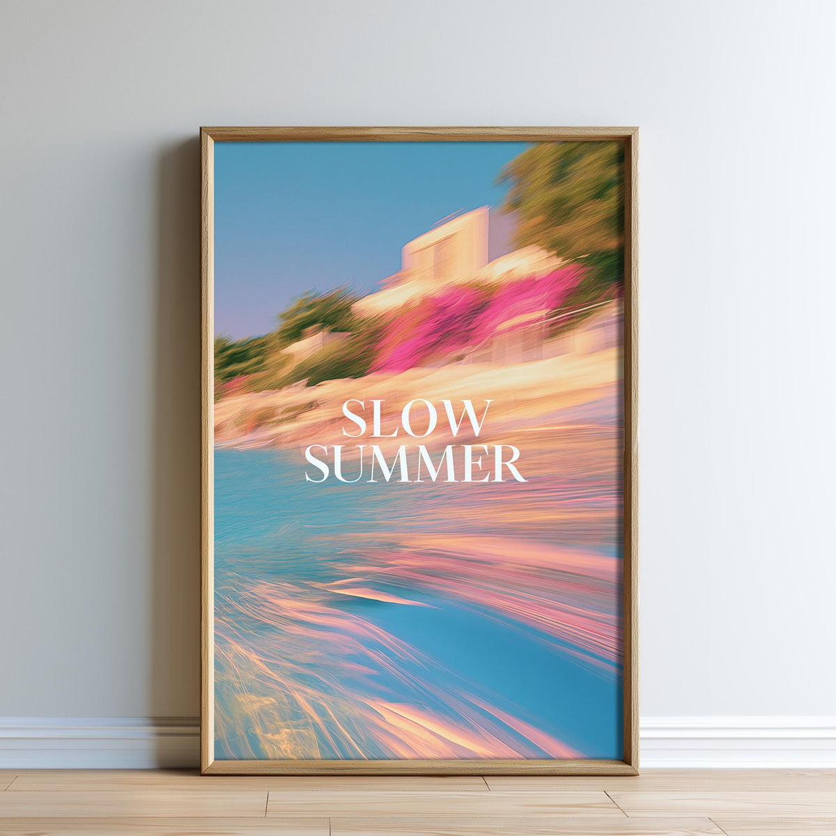 The image is a framed poster with a blurred, colorful background depicting a beach scene with a building and trees. The text "SLOW SUMMER" is prominently displayed in the center of the poster.