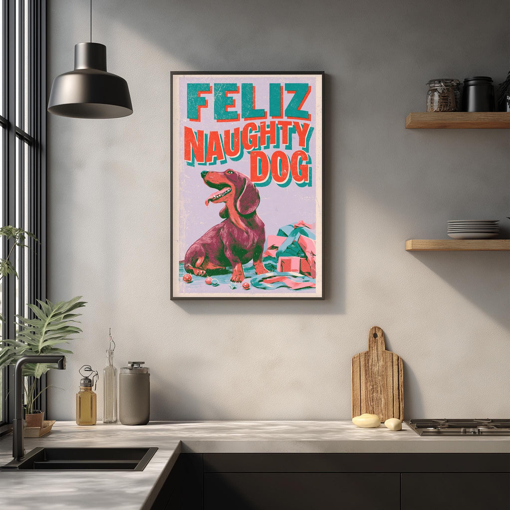 a framed poster of a dog with the text "Feliz Naughtily Dog" on it, hanging on a wall above a kitchen counter.
