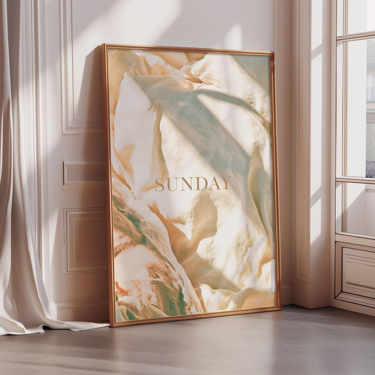 A large framed poster with a textured, abstract design is displayed on a wall in a room with sunlight streaming in from a window.