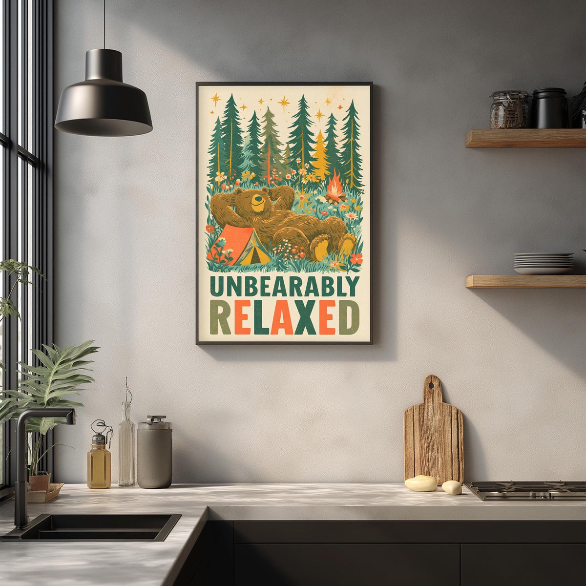 a framed poster with a bear and camping scene, hanging on a wall above a kitchen counter.