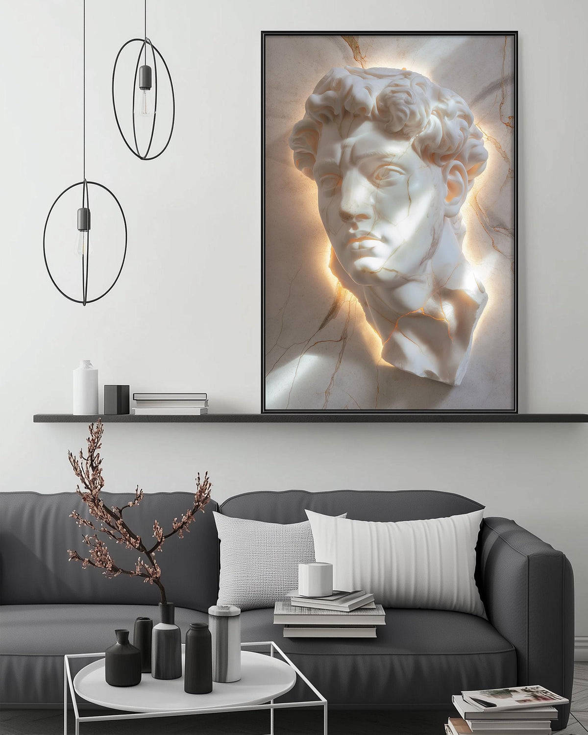 a modern living room with a gray sofa, a coffee table, and a large framed artwork of a marble bust above it. The artwork is illuminated by a light source, creating a warm glow around it. The room also includes a shelf with decorative items and a potted plant, adding to the overall aesthetic of the space.