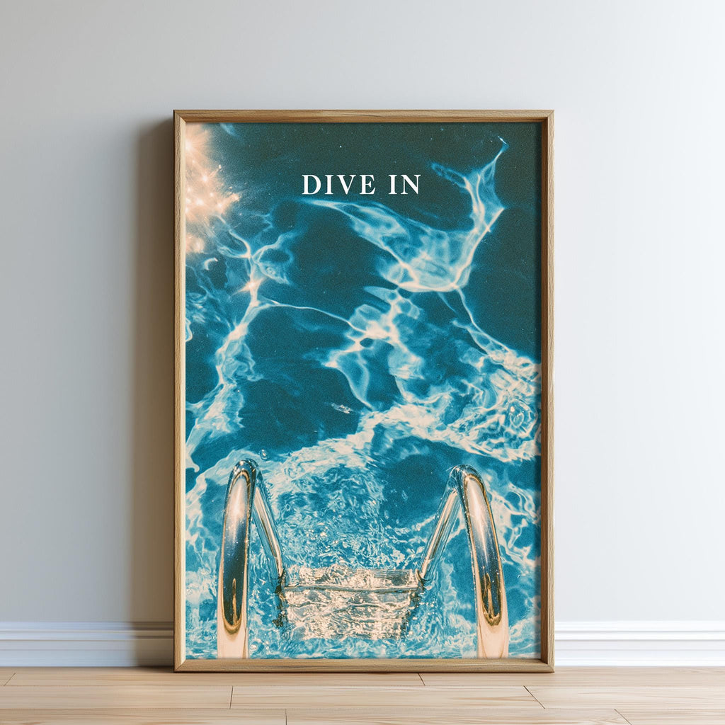 The image is a framed poster with a photograph of a swimming pool and a ladder, along with the text "DIVE IN" prominently displayed.