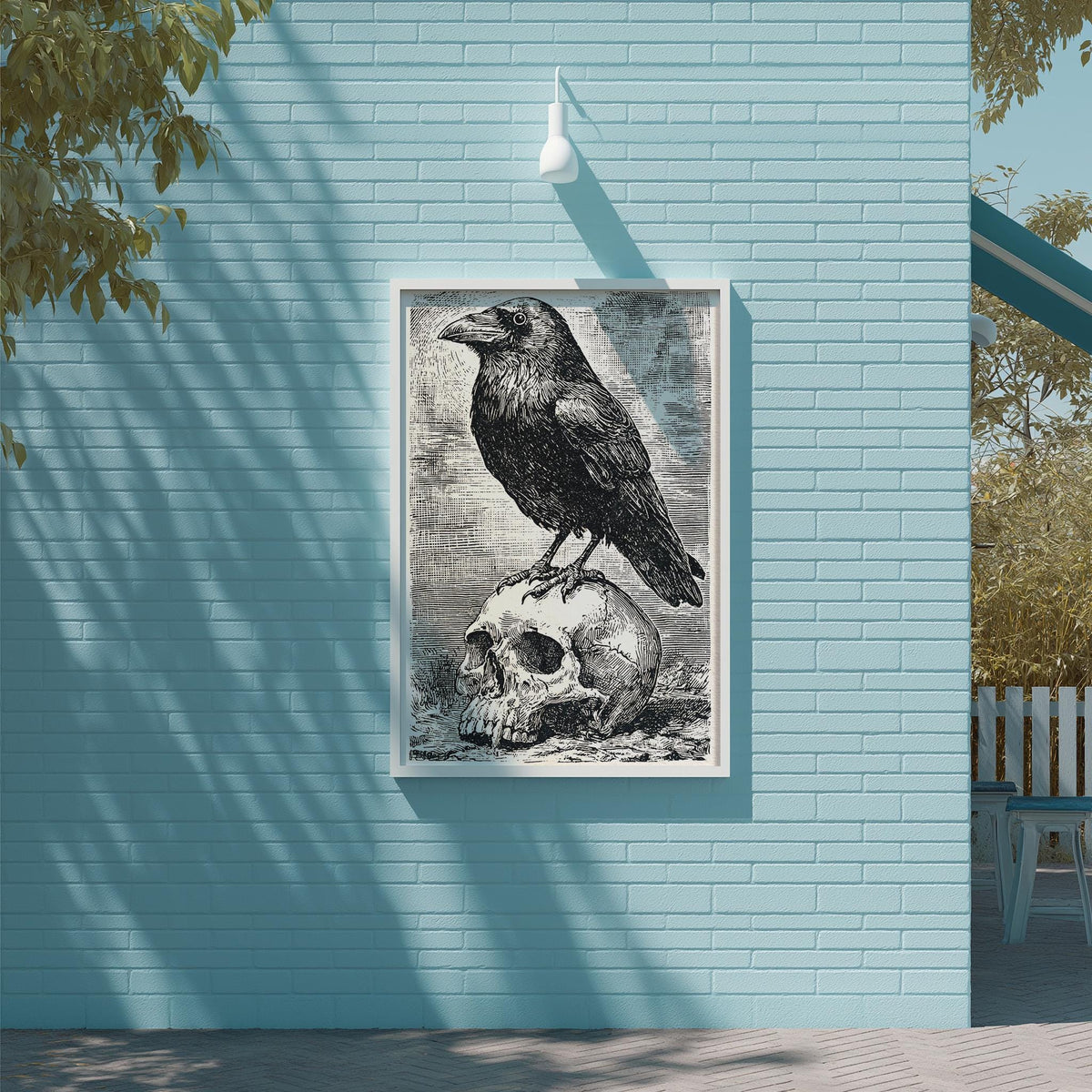 a framed illustration of a black crow perched on a skull, mounted on a blue brick wall.