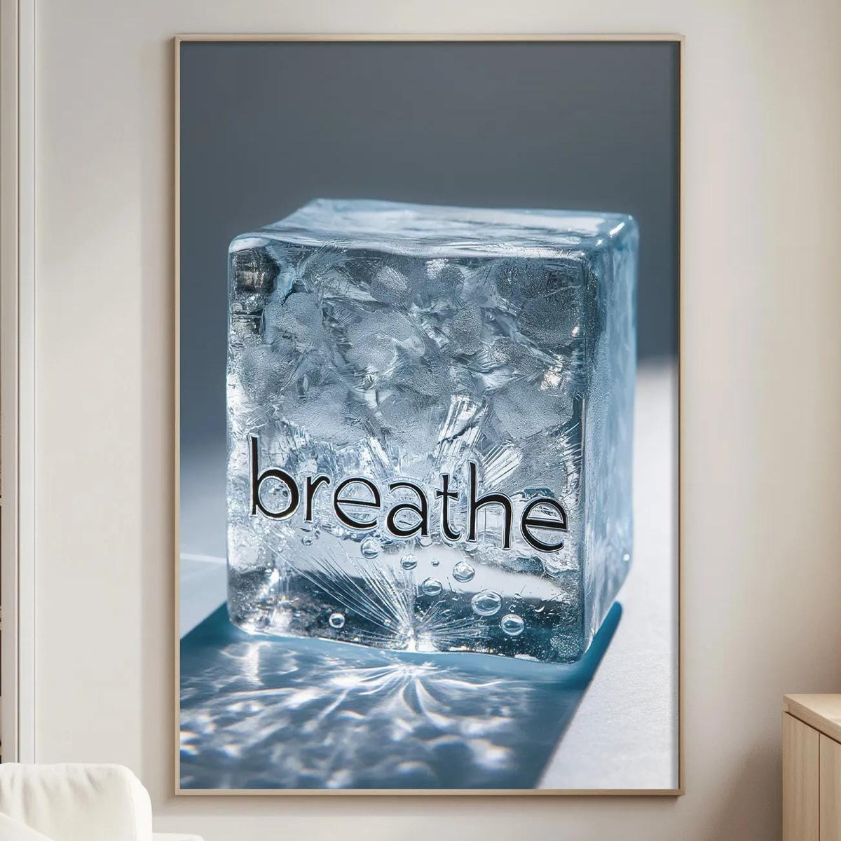 a large framed picture hanging on a wall in a living room, depicting a block of ice with the word "breathe" written on it.