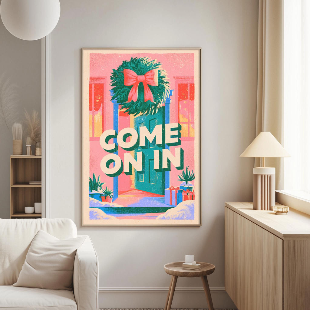 a living room with a large, colorful poster hanging on the wall. The poster has a wreath and presents the phrase "COME ON IN" in bold letters.