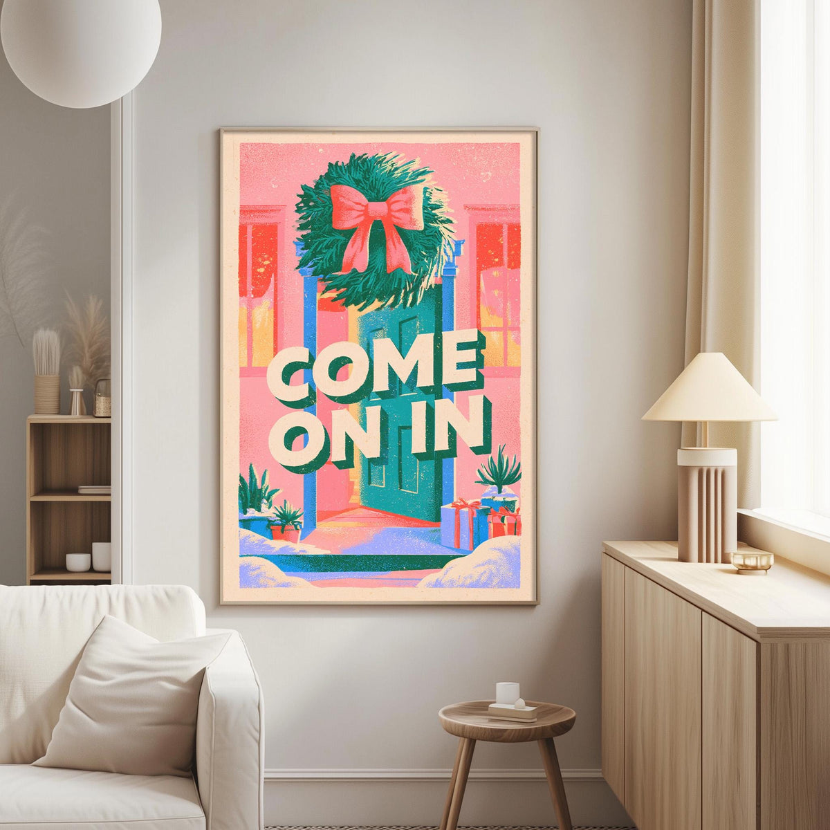 a living room with a large, colorful poster hanging on the wall. The poster has a wreath and presents the phrase "COME ON IN" in bold letters.